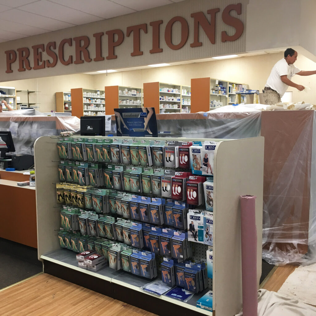 Retail painters prepping and painting a pharmacy