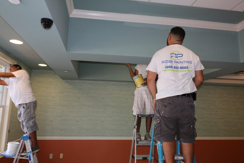 Senior Living facility painters painting a lounge area vibrant colors to encourage social interaction